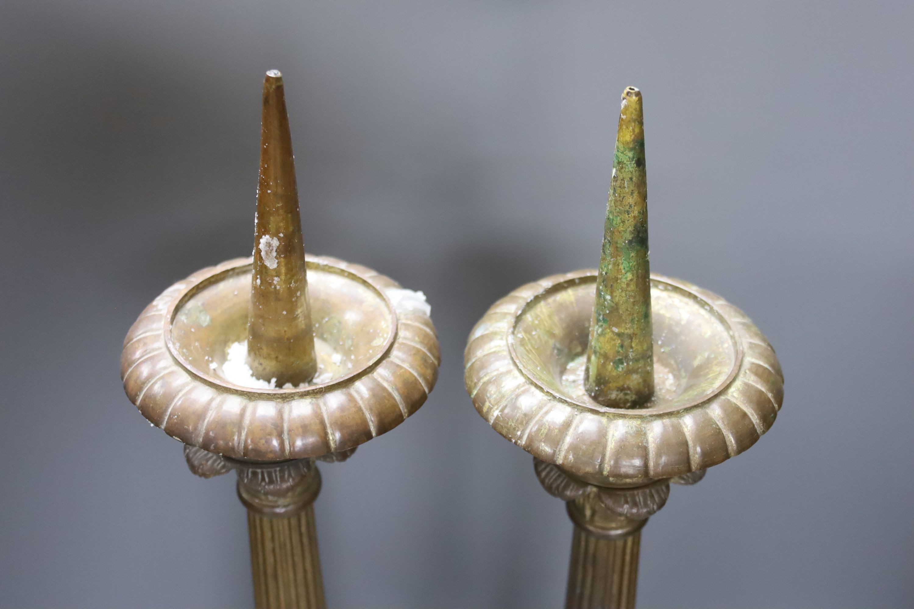 A pair of gilded brass pricket candlesticks 61cm